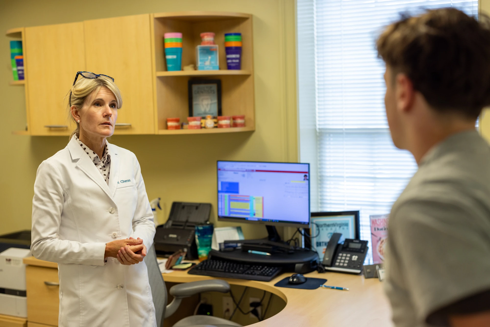 Dr. Cheron discussing a treatment plan with a patient in the consultation room